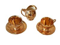 Set shows two teacups with saucers and cream bowl on white background