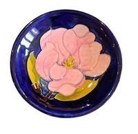 Front view of Moorcroft plate showing pink magnolia design