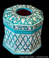 Top view of octagonal box showing mother-of-pearl floral inlay and red velvet interior opening