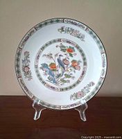 Front view of Wedgwood Kutani Crane plate on stand