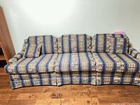 Front view of full sofa showing length, three cushions, skirted base and pattern