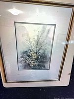 Close-up of artwork showing floral subject and mat