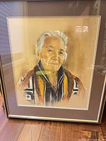 Full view of framed portrait under glass