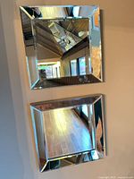 Both square mirrors mounted on wall showing size and matching design