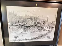Full view of framed pen & ink drawing showing waterfront scene, mat and frame visible