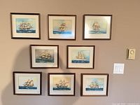 Wall view of eight framed nautical prints