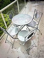 Entire bistro set on balcony: table and four chairs