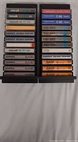 Two columns of 12 cassettes showing all 24 tapes in cases