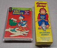 Toy box front beside stack of comics