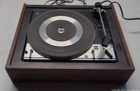 Top view of Dual 1214 turntable showing platter, tonearm and wooden plinth