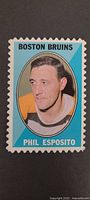 Front view showing Phil Esposito portrait, Boston Bruins title, perforated edges