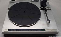Full view of Yamaha P-200 turntable showing platter, tonearm, controls, and dust cover