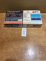 Both boxed stereos side by side showing model information on lids