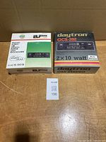Two boxed vintage car stereos on table: Daytron GCS-202 and ELFone EL-9202i, MaxSold lot slip visible