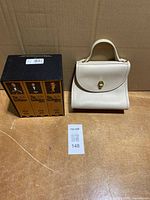 Coach purse front view beside The Godfather VHS box set