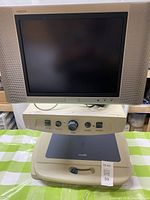 Front view of CCTV magnifier showing Sharp Aquos monitor and control console