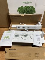 Full kit showing base, LED arm, accessories, manual and box