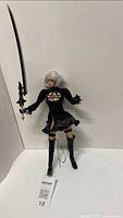Full view of 2B figure standing with sword