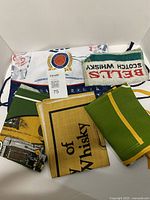 Stack of bag and assorted bar towels showing logos and colors