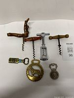 Group shot of six bottle openers and corkscrews