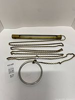 Thermometer, chain and ring displayed flat