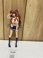 Full assembled figure leaning against wood panel, missing base