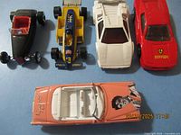 Top view of five toy cars lined up