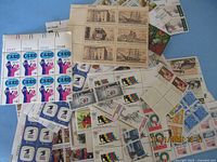 Pile of assorted unused U.S. commemorative stamps including 3¢ CARE block, 2¢ blocks and various multicolour issues