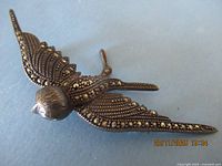 Front view of owl brooch showing marcasite detail