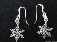 Pair of sterling silver snowflake dangle earrings