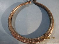 Full view of circular torque necklace showing overall design and size