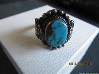 Front view of sterling ring showing turquoise cabochon and decorative bezel