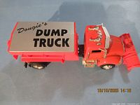 Full view of toy dump truck from above, showing dump bed lid text