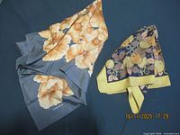 Both scarves laid flat showing overall patterns and colours