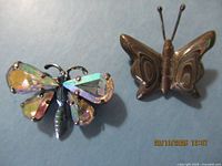 Both butterfly brooches front view
