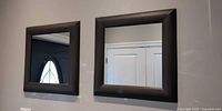 Both square mirrors mounted side-by-side on wall