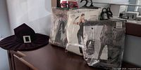 Costumes in packaging and witch hat on dresser