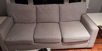 Front view of grey three-seat sofa
