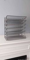 Front view of five-tier grey metal mesh file organizer