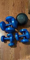 All dumbbell pairs and medicine ball on floor