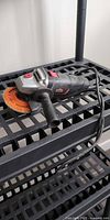 Overall view of Jobmate corded angle grinder on shelf