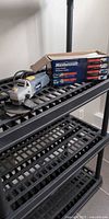 Angle grinder on shelving with retail box