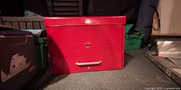 Front view of closed red metal tool chest
