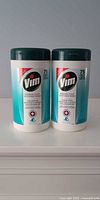 Front view of two Vim disinfectant wipe canisters