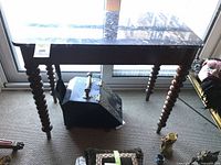 Front view of oak table showing marble top and barley twist legs