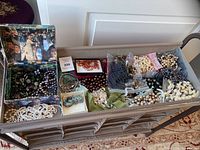Full view of fabric cart shelf filled with assorted jewelry pieces