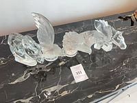 All six crystal pieces lined up on marble surface