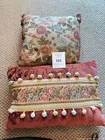 Square pillow and rectangular pillow grouped on carpet