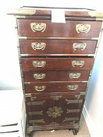 Front view showing five drawers, brass hardware, lower cabinet doors