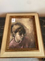 Front view of framed portrait painting showing image, frame, and signature